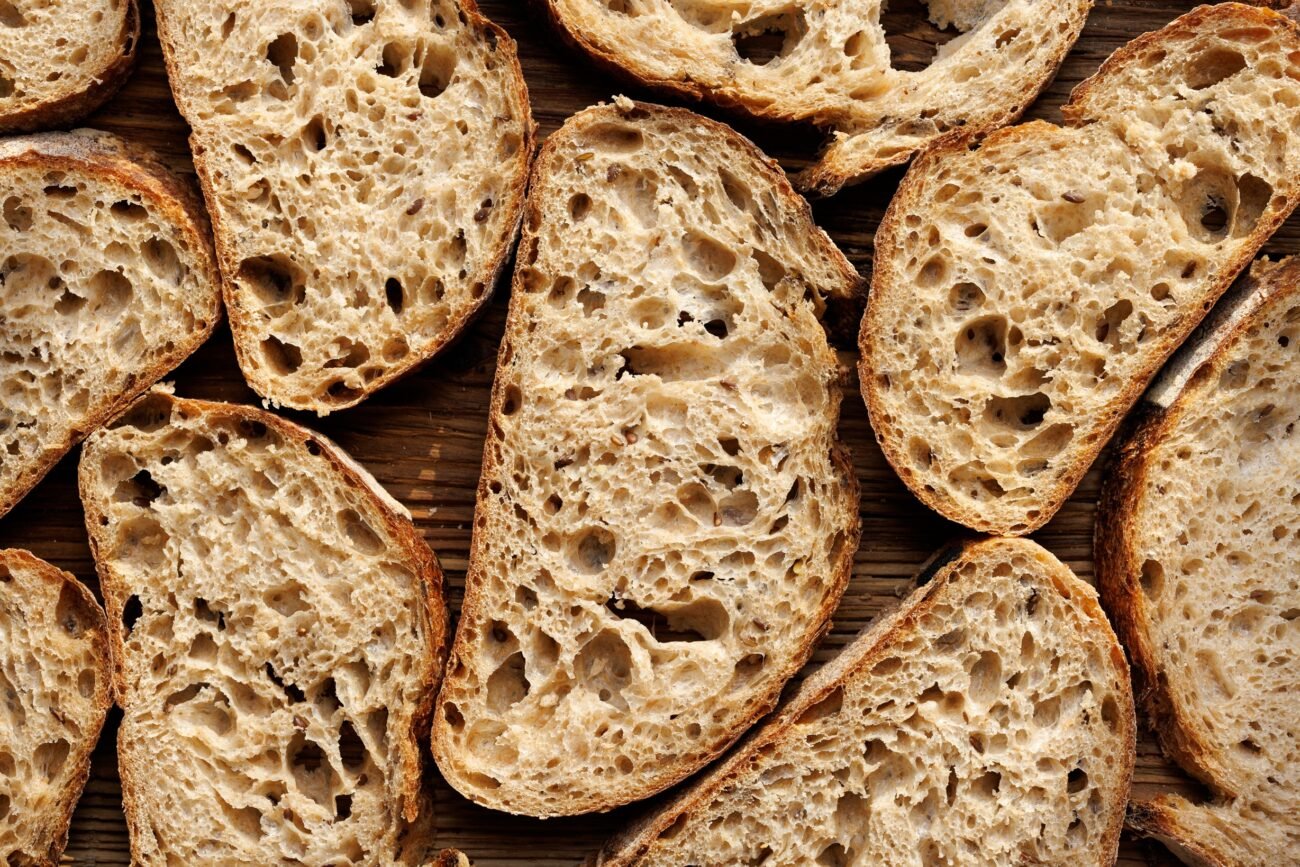 Sourdough bread slices on wooden background